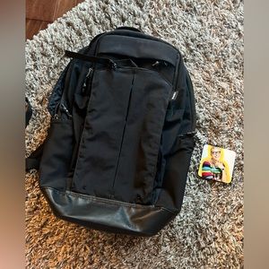 Thule laptop/travel backpack. Many pockets for many sized items. See video.